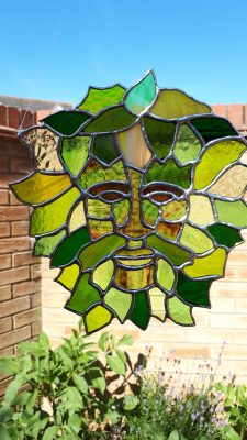 Stained glass suncatcher depicting The Green Man