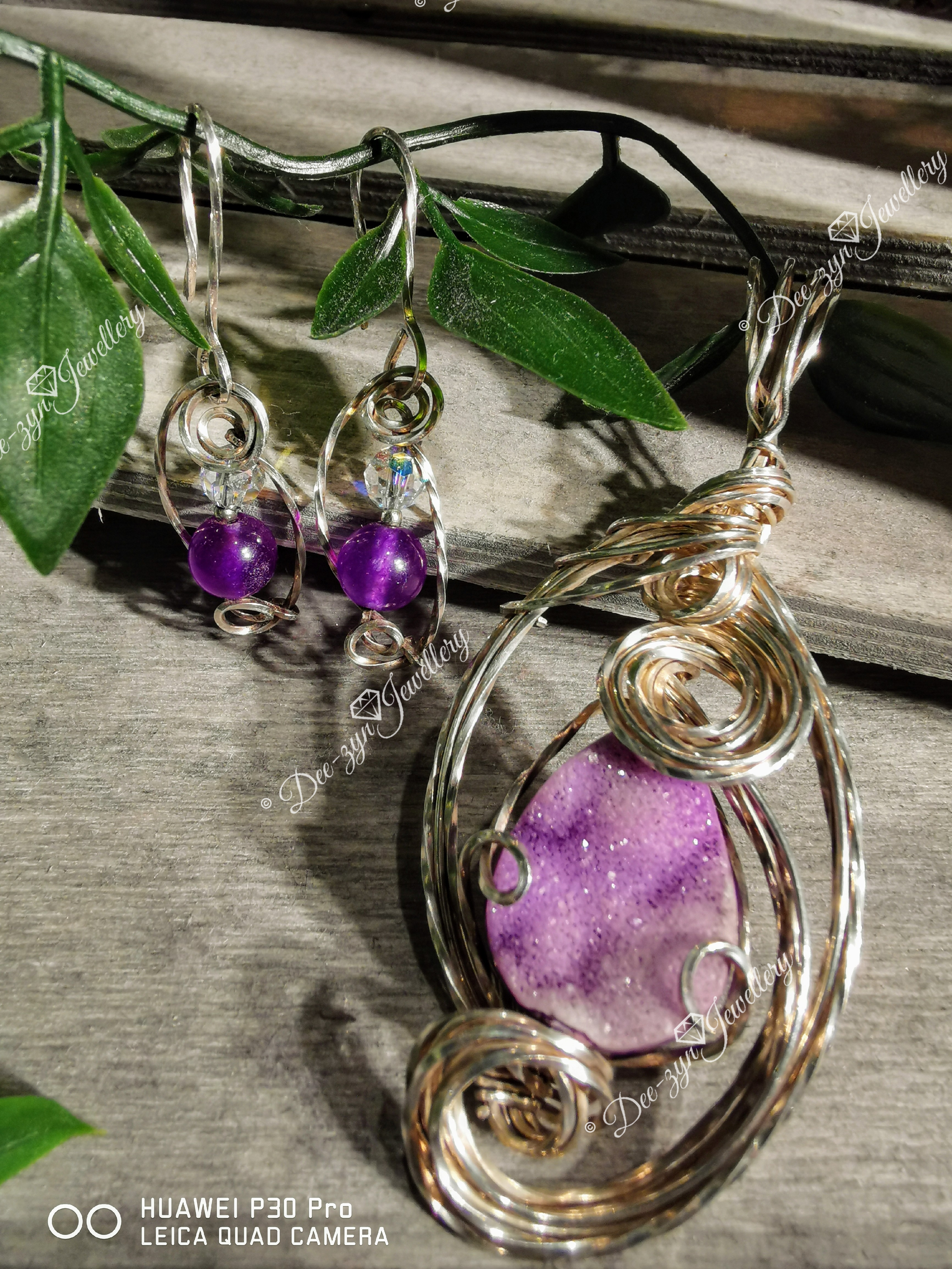 Sterling silver Swirl jewellery encasing amethyst stones in earrings and a large Agate in a pendant setting.