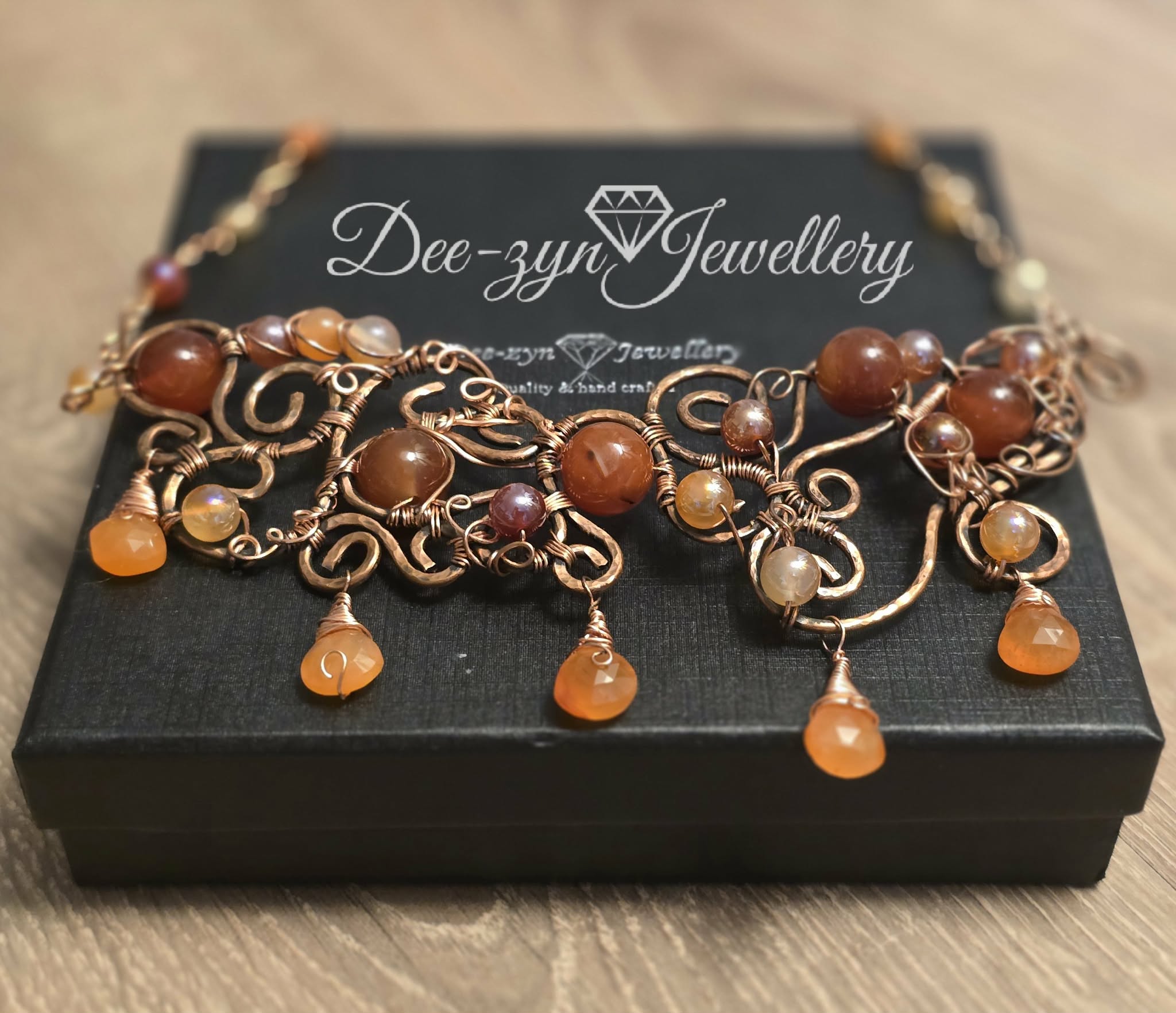 Copper and Carnelian necklace on a black jewellery box