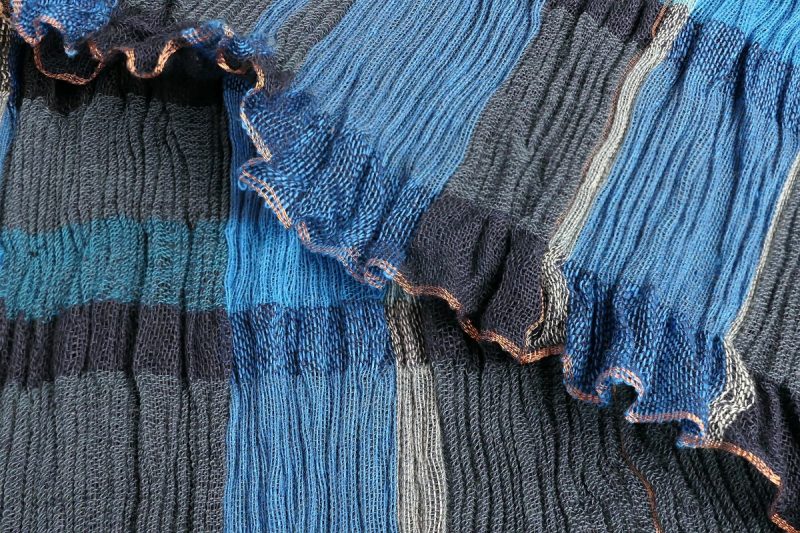 Through my handwoven textiles created on a multi-shaft floor loom I explore colour, texture and technique to create a variety of finished pieces for home and to wear.  I enjoy using a variety of techniques and yarns.
