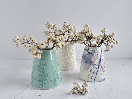 Small porcelain vases, hand decorated with textured slip trailing. Spring colours, pretty flowers.