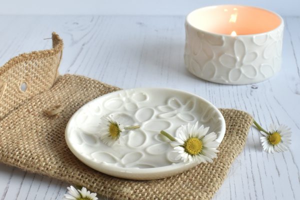 white porcelain, wheel thrown ring dish on a blue book